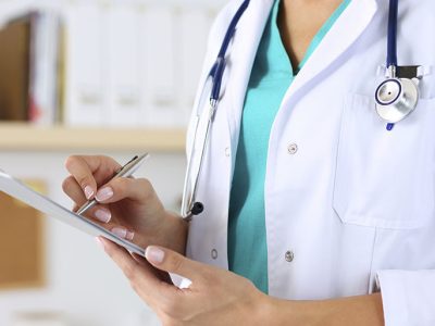 Female medicine doctor hand holding silver pen writing something on clipboard closeup. Medical care, insurance, prescription, paper work or career concept. Physician ready to examine patient and help